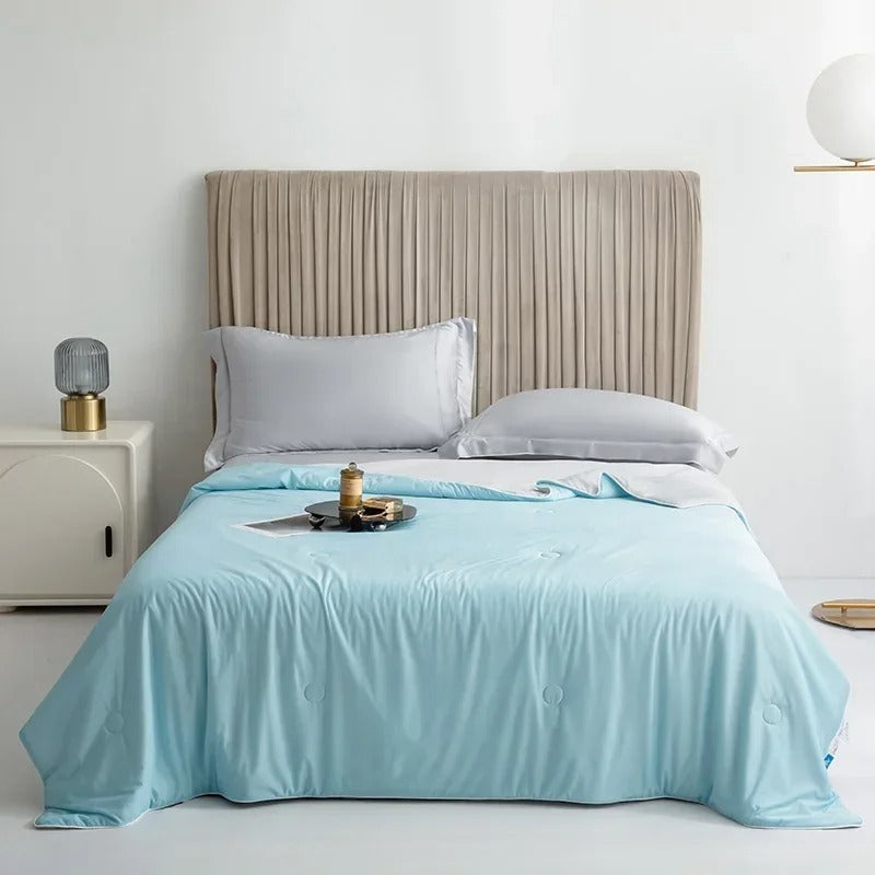 Summer Cooling Blanket in Sky Blue spread over a bed