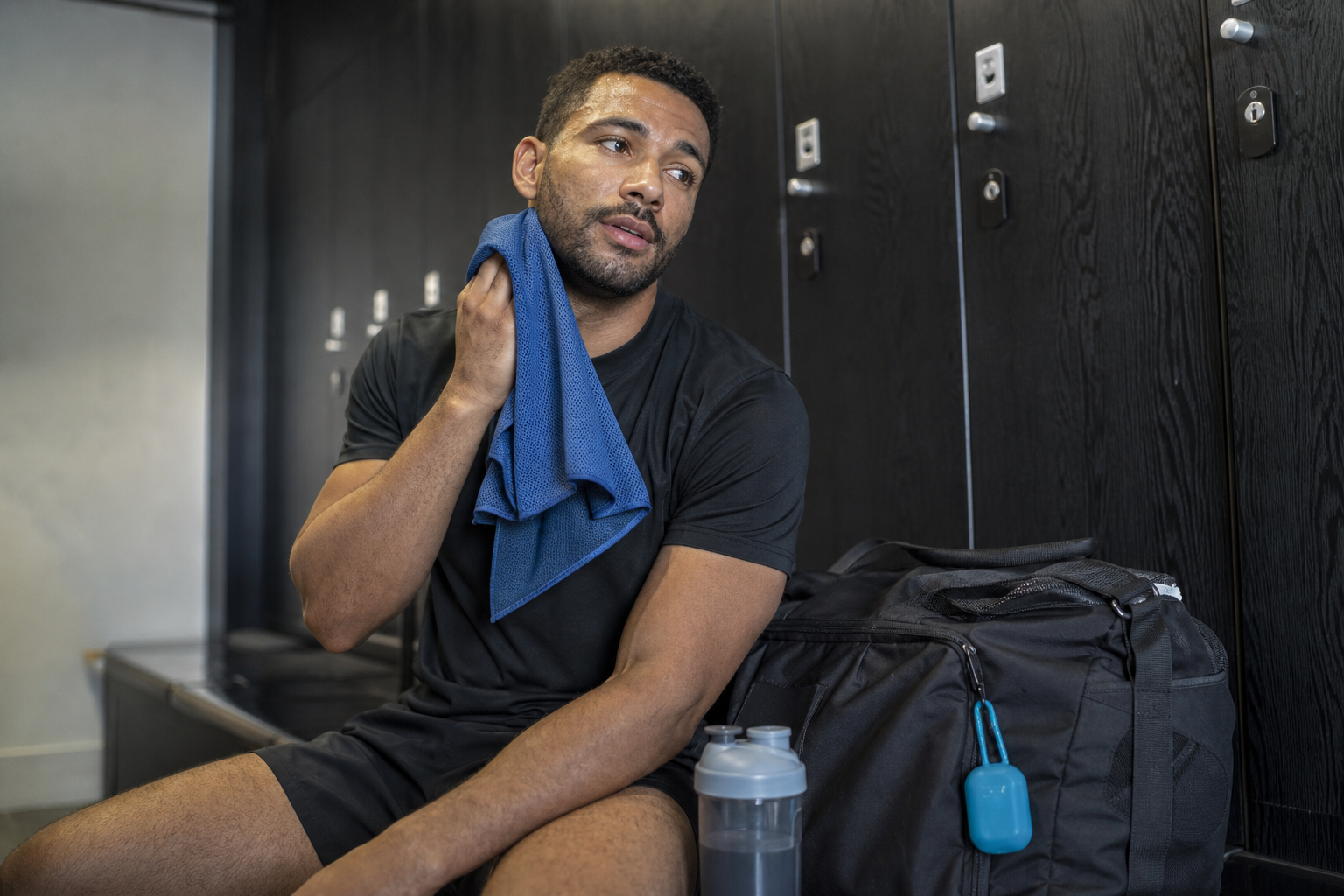 Man using a cooling towel in a gym changing room