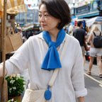 Cooling towel tied around the neck at an outdoor market