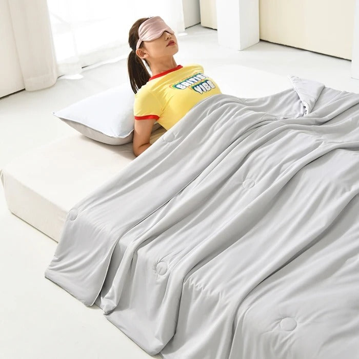 Summer Cooling Blanket in Gray shown in use on a bed