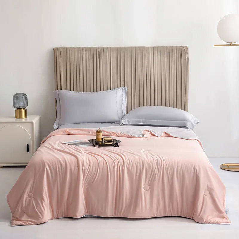 Summer Cooling Blanket in pink spread over a bed