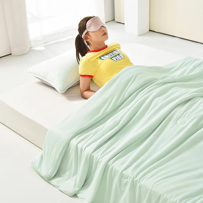 Supplier photograph showing the Green blanket draped over a person